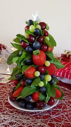 a christmas tree made out of fruit on a table