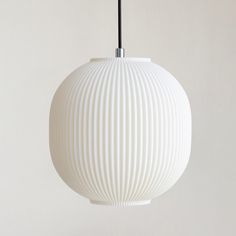 a white ball shaped light hanging from a ceiling