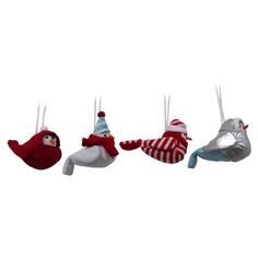 christmas ornaments hanging from strings in the shape of birds with hats and scarfs on them