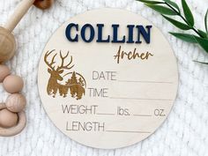 a personalized wooden birth announcement with an antelope and deer design on it