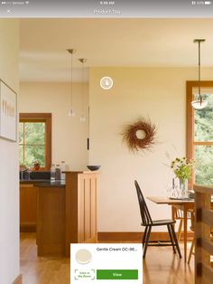 an image of a dining room with wood flooring and furniture on the screen,