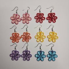 six pairs of earrings with colorful flowers on them