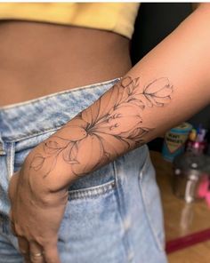 a woman with a flower tattoo on her arm