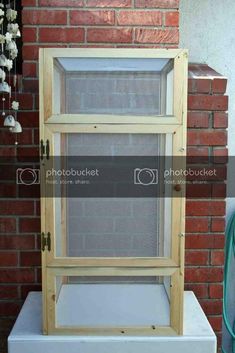 an old window sitting in front of a brick wall