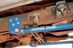 there is a blue pipe attached to the underside of an old car that says james duff