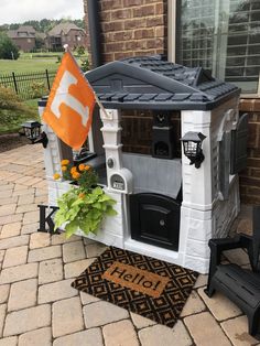 an outdoor play house with a flag on the front door