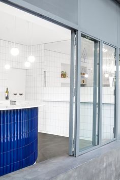 the inside of a building with blue and white tiles on the walls, windows, and floor