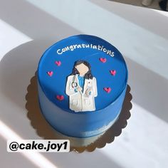 a blue cake decorated with an image of a doctor