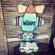 a wooden sign that says william with an airplane on it's back and the word william written in large letters