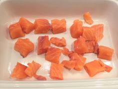 raw salmon cubes in a plastic container