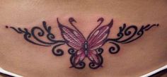 a woman's back with a butterfly tattoo on her lower back and the word love written in cursive writing