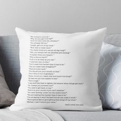 a white pillow sitting on top of a couch next to a gray throw pillow with the words