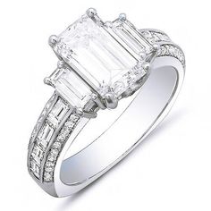 A fascinating diamond ring that will bring years of memories. The center diamond is a gorgeous emerald cut diamond. The diamond has a weight of 2.00 carats. The clarity ranges from VS1 with a color grade of G. Additional side diamond contains 0.50 Ct. of baguette cut diamonds complimenting the center stone, 0.50 Ct. of baguette cut diamonds flowing down the shank as channel set, and 0.30 ct. Round brilliant cut diamonds set as micro pave. split Metal : Available in 14K Gold, 18K Gold or Platinum Ring Types, 3 Stone Diamond Ring, Baguette Engagement Ring, Emerald Cut Diamond Engagement Ring, Emerald Cut Diamond Engagement, Emerald Cut Diamond Ring, Emerald Cut Engagement, 3 Stone Engagement Rings, Emerald Engagement Ring Cut