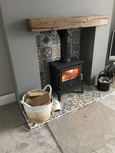 a wood burning stove sitting inside of a living room next to a tv on top of a rug