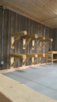 a room with wood planks on the wall and wooden benches in front of it