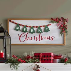 a fireplace mantle decorated with christmas decorations