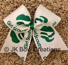 "Girl Scout bow, features the Girl Scout logo in green on a white background. Made on 3\" ribbon, available with elastic tie, alligator clip or barrette." White Ribbon Bow For Gift, Cute White Bow With Ribbon, Cute White Ribbon Bow, Green Satin Bow For Gifts, Girl Scout Logo, Scout Logo, Girl Scout Gifts, Daisy Girl Scouts, Cheer Gifts