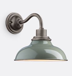 an industrial style wall light with a green shade on the top and white back ground