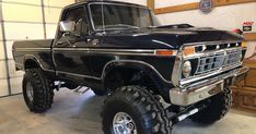 a large black truck parked in a garage