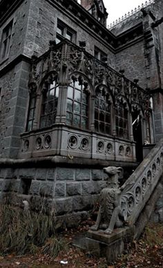 an old building with a statue in front of it and stairs leading up to the entrance