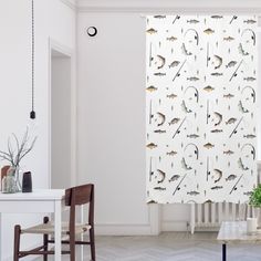 a living room with white walls and curtains featuring birds on the wall next to a window