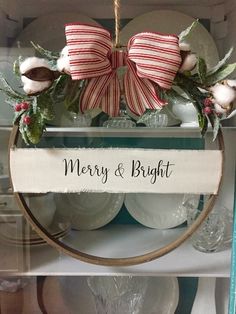 a merry and bright sign hanging from the side of a shelf