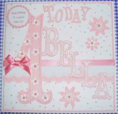 a pink and white greeting card with a bow