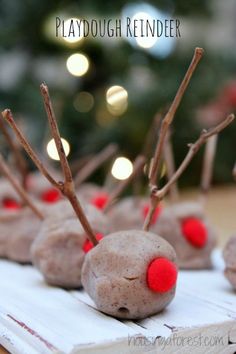 some kind of playdough reindeer made out of doughnuts with red noses