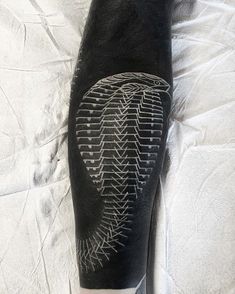 a man's leg with an intricate tattoo design on the side of his calf