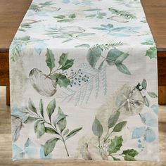 an image of a table cloth with leaves and flowers on it