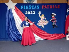 a woman in a red, white and blue dress standing next to a flag