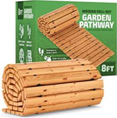 the garden pathway is made out of wooden planks and has been placed in front of a box