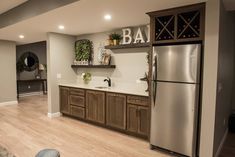 a kitchen with wooden cabinets and stainless steel refrigerator freezer next to a counter top