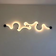 a wall mounted light that is on the side of a wall with two lights attached to it