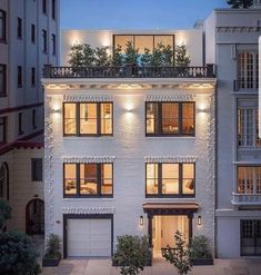 an apartment building with lights on the windows