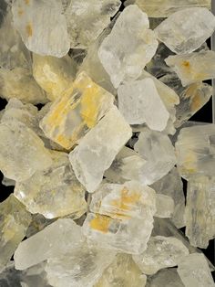 some yellow and white rocks on a black background