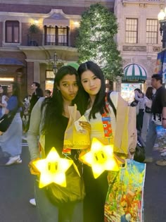 two women standing next to each other holding shopping bags