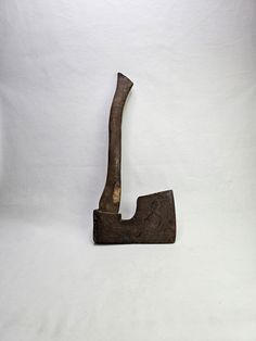 an old metal hammer with a wooden handle on a white background in the shape of a letter j