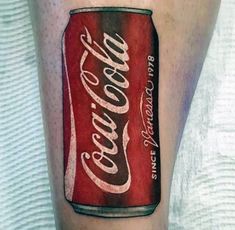 a man with a tattoo on his leg that has a coca cola can painted on it