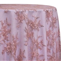 a table cloth with pink flowers on it and gold sequins around the edges