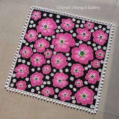 a black and pink rug with flowers on it