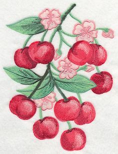 an embroidered cherry branch with pink flowers and green leaves