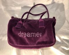 "Bath and Body Works - A deep purple puffy velvet zippered pouch with silver sparkly \"dreamer\" on the front.  A perfect whimsical yet practical and roomy bag to brighten up the moment! * dimensions: 10\" x 7\" x 4 1/2\" tapered to 4\" *  lined in a smooth purple satin  * a zippered wall pocket * a pair of 18\" purple grograin straps.  * excellent condition please note: ALL my bags are carefully hand cleaned to ensure a pristine freshness item# ev/147" Purple Satin, Zippered Pouch, Wedding Bag, Wall Pockets, Grog, Deep Purple, Bath And Body Works, Body Works, Zipper Pouch