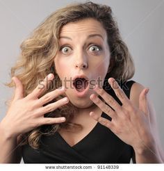 a woman making a surprised face with her hands