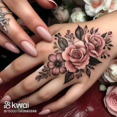 a woman's hand with flowers on it