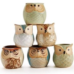 an assortment of ceramic owls sitting on top of each other