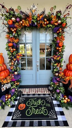 an entrance decorated with halloween decorations and pumpkins