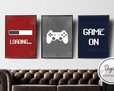 three video game posters are hanging on the wall above a brown couch in a living room