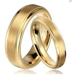 two gold wedding rings with the word love written on each one in cursive writing