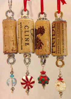 four wine corks hanging from red ribbon with charms attached to each one and the other side